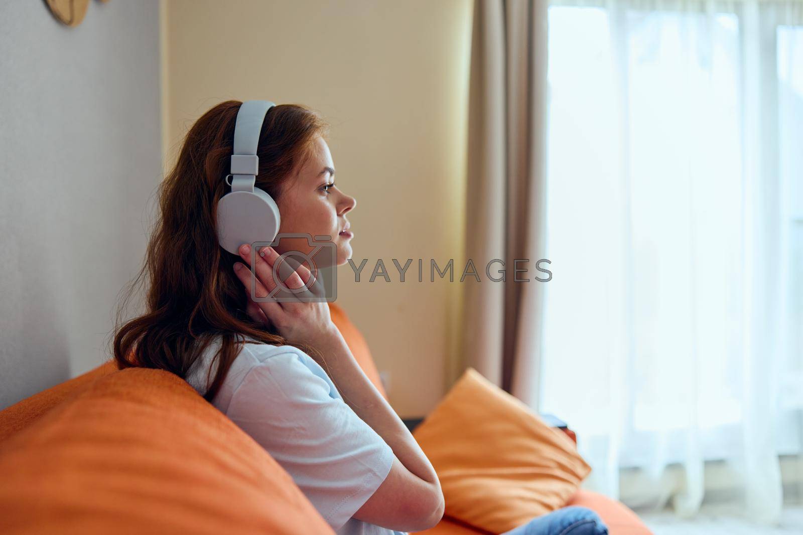 portrait of a woman headphone at home on the couch entertainment Lifestyle. High quality photo