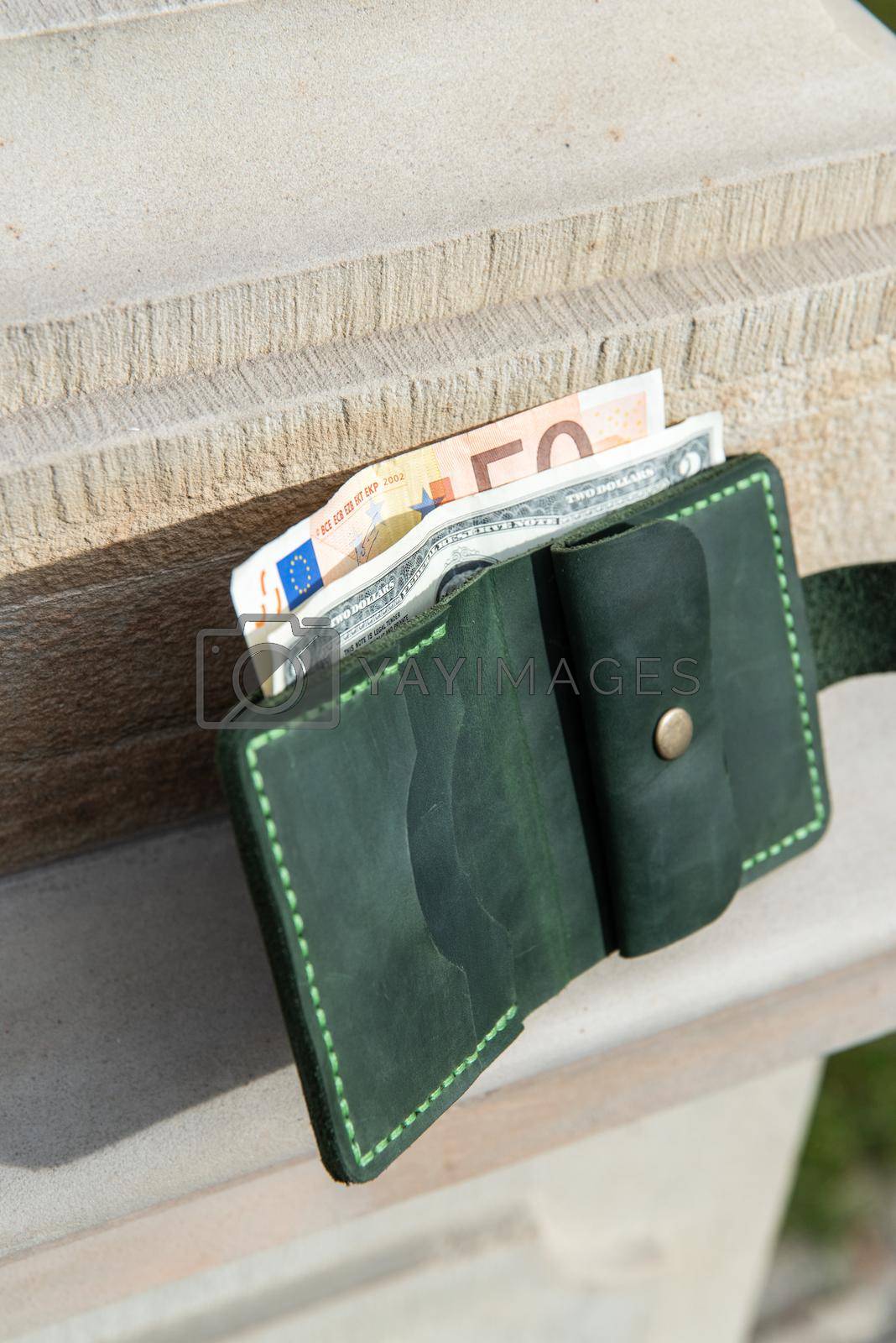 Royalty free image of hand made leather wallet . Leather craft. Selective focus by Ashtray25