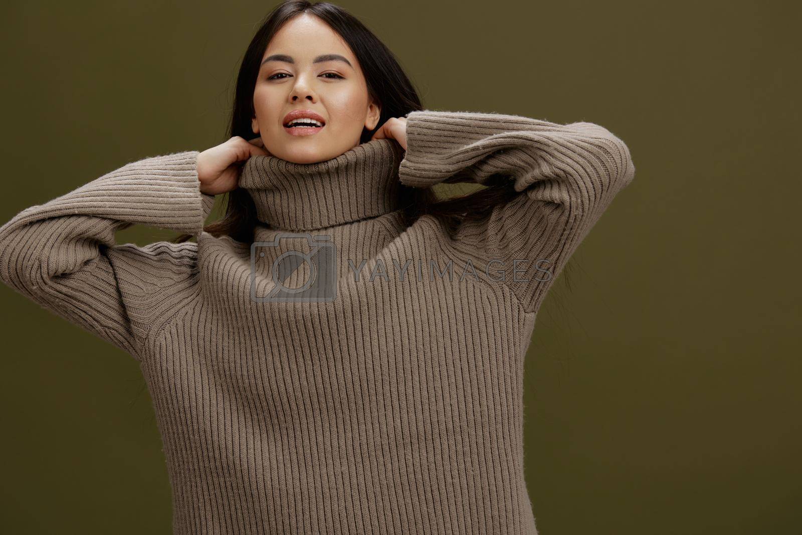 pretty woman in a sweater posing smile clothing fashion studio model. High quality photo