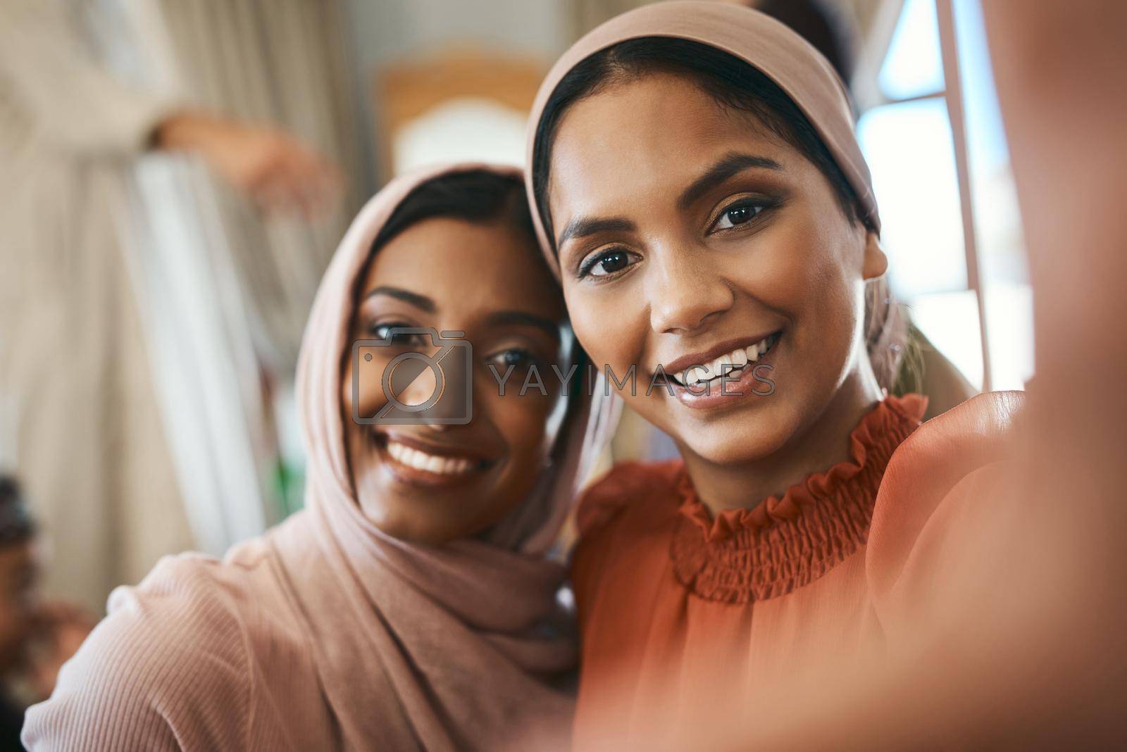 Royalty free image of There is no greater love than sibling love. Shot of two muslim sisters taking selfies together. by YuriArcurs