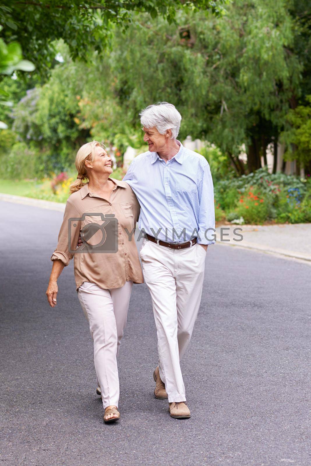 Royalty free image of Love never dies. Shot of a happy senior couple walking. by YuriArcurs