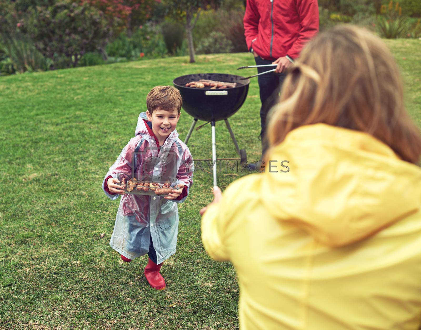 Shot of a family enjoying a barbecue outside.