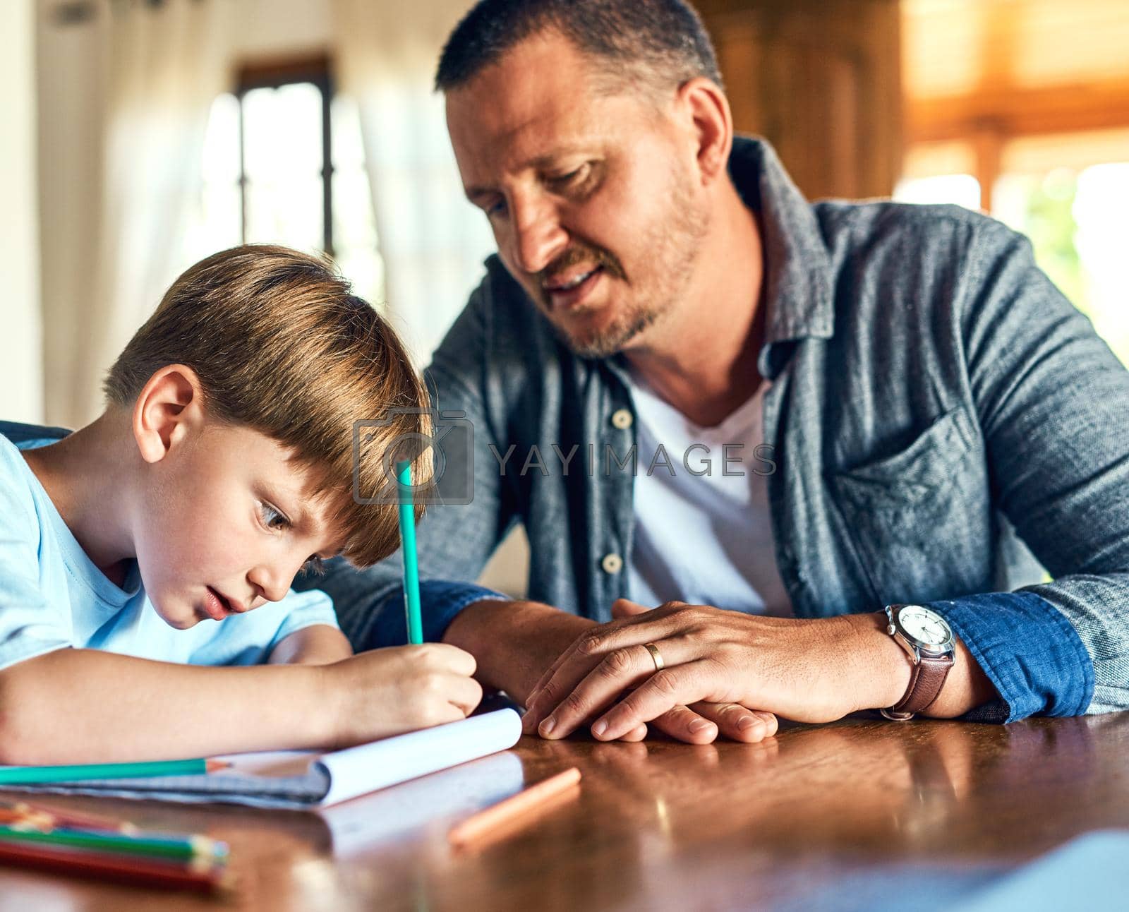 Shot of a father helping his son with his homework.
