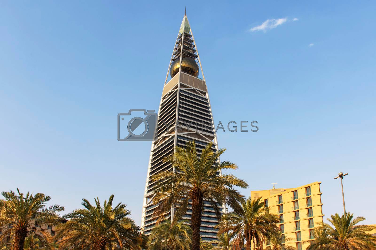 Riyadh, Saudi Arabia, KSA - August 25, 2021 Al Faisaliah Tower Skyscraper with palm trees in Riyadh