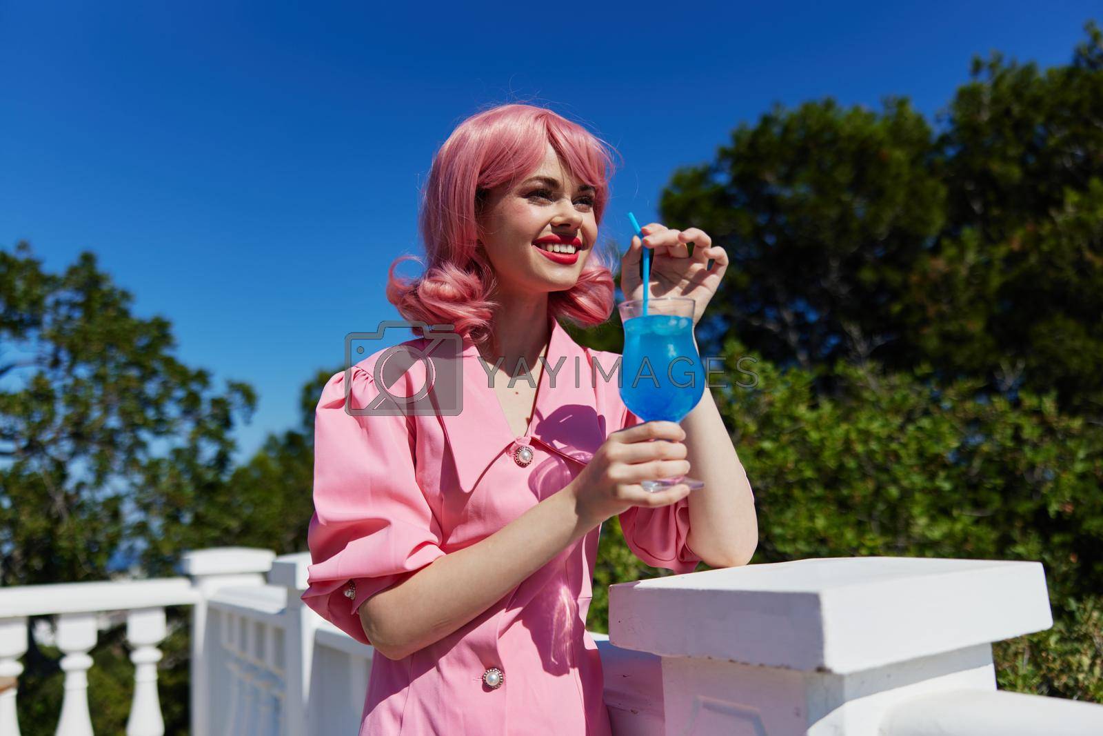 glamorous woman with pink hair summer cocktail refreshing drink Summer day. High quality photo