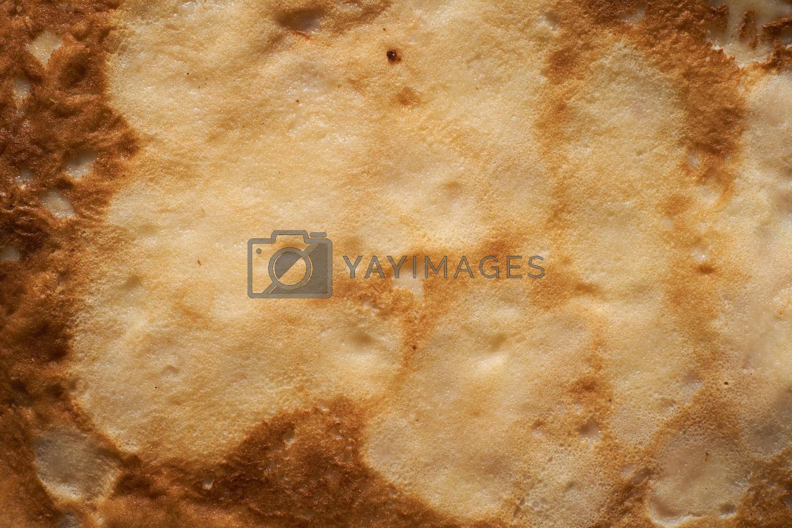 Texture of a cooked thin pancake closeup. Fried pancakes.