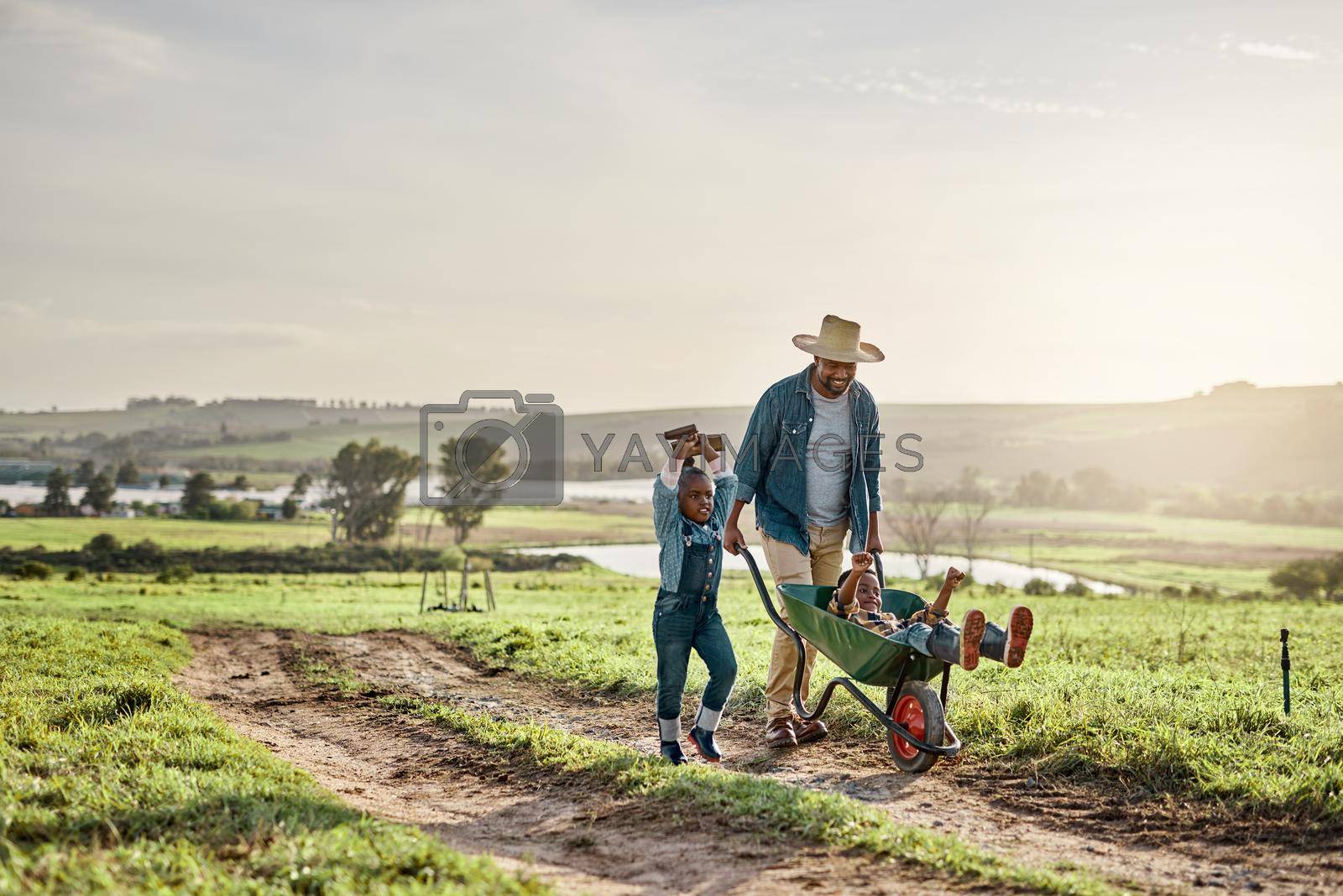 Shot of a mature man working his adorable son and daughter on a farm.