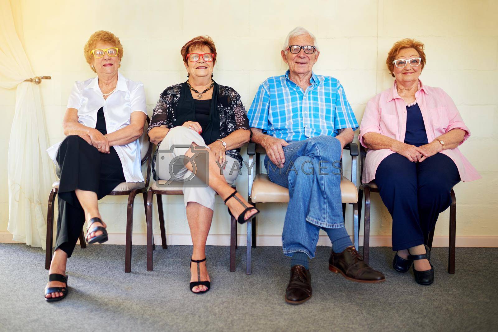 Shot of a group cheerful elderly people smiling and posing for the camera inside of a building.