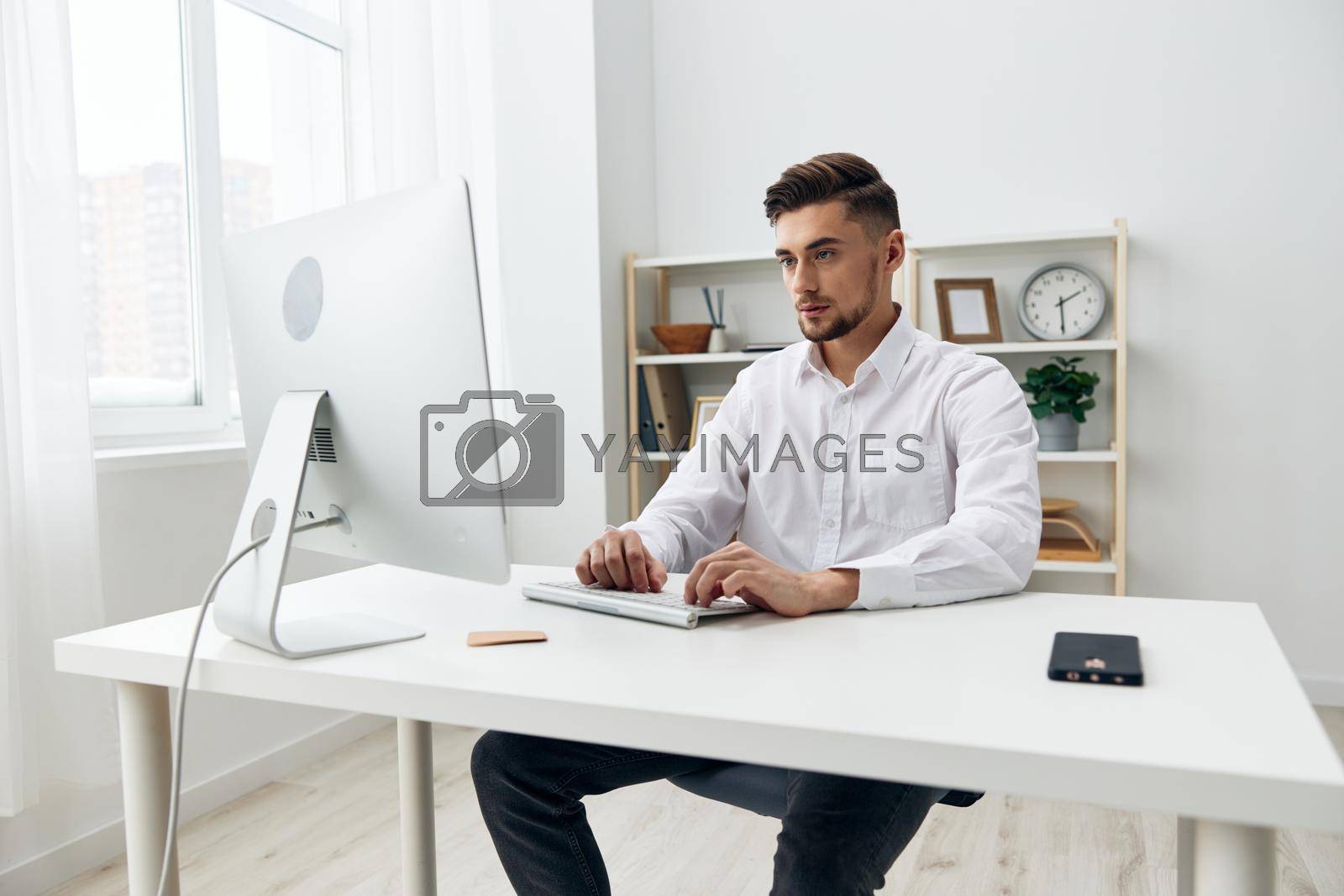 Royalty free image of handsome businessman office worker in a white shirt workplace by SHOTPRIME