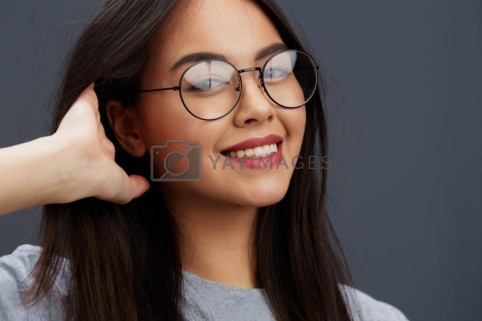 pretty woman glasses on face fashion lifestyle gray t-shirt Gray background. High quality photo
