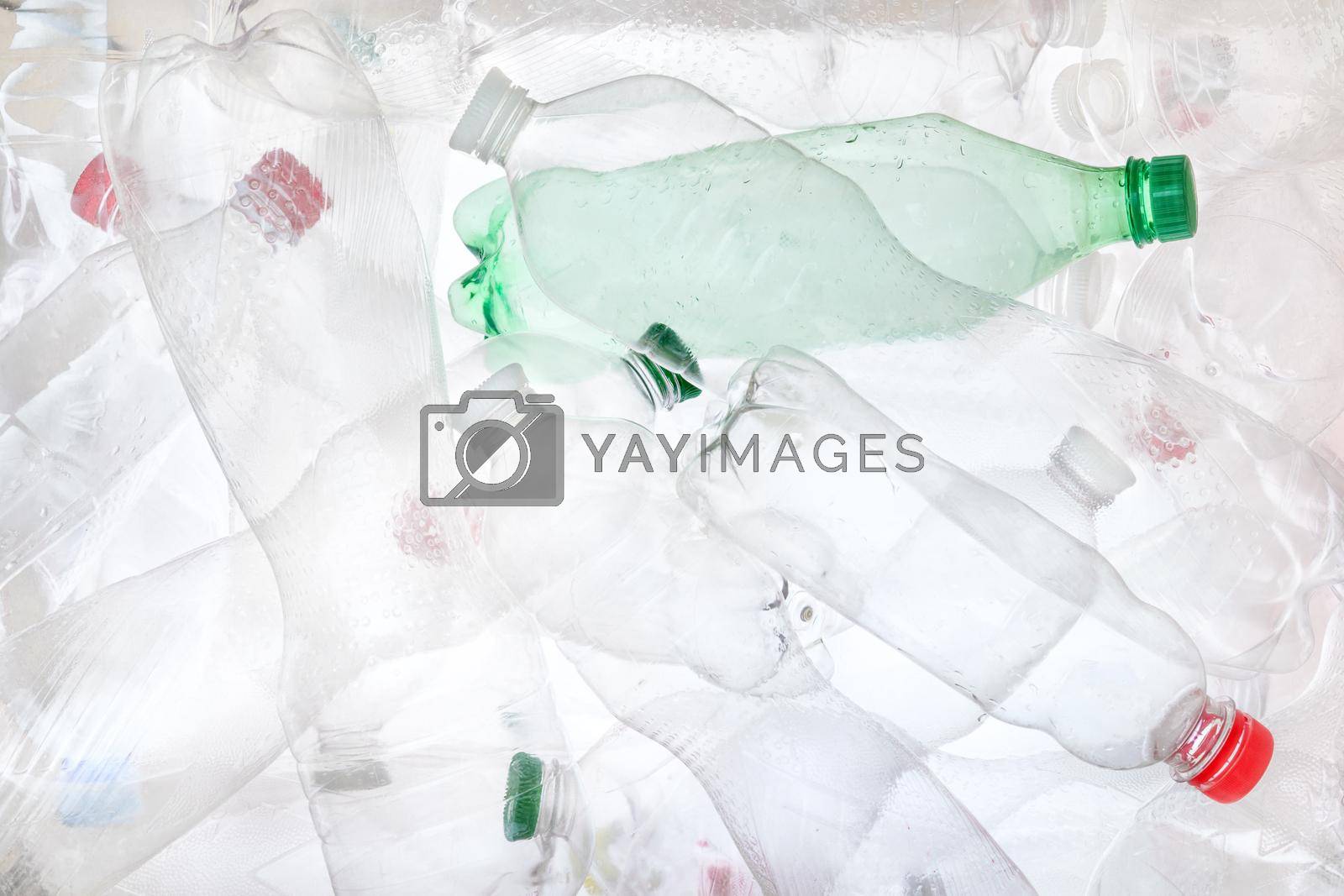 Many bottles transparent plastic PET recycling waste. Empty plastic bottles background. Water PET bottle recycling plastic material recyclable waste sorting. Recyclable trash recycle garbage concept