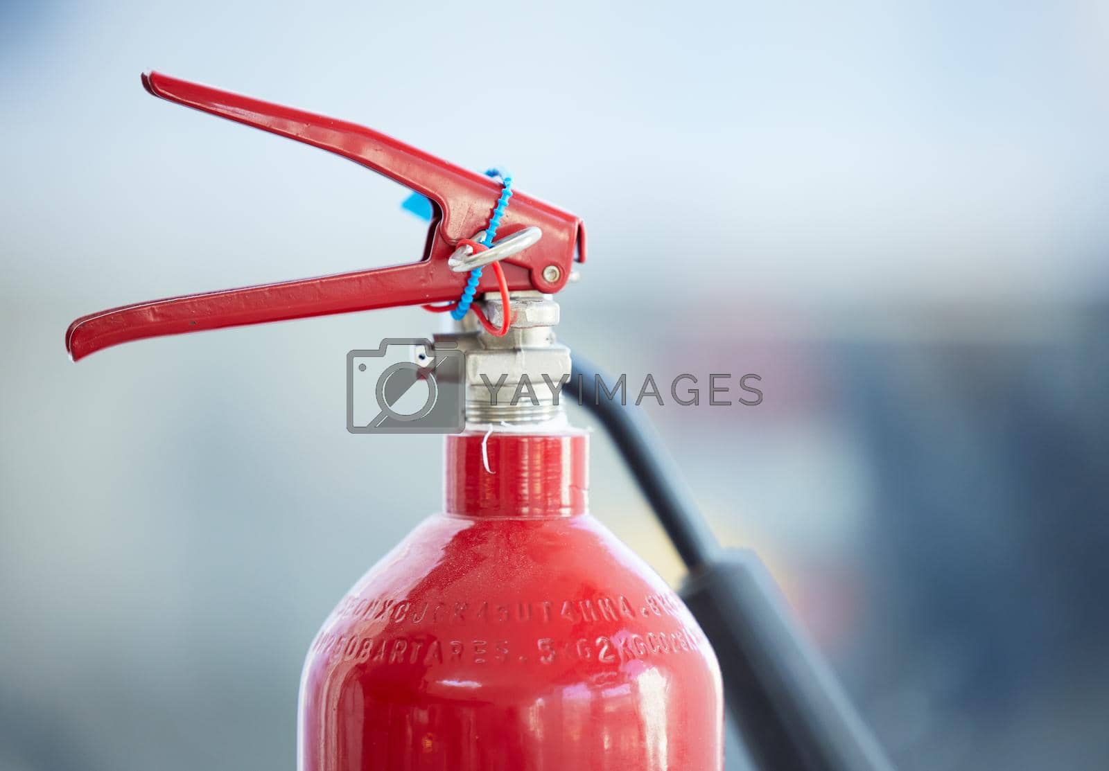 Royalty free image of In case of fire, look for me. Shot of a red fire extinguisher. by YuriArcurs