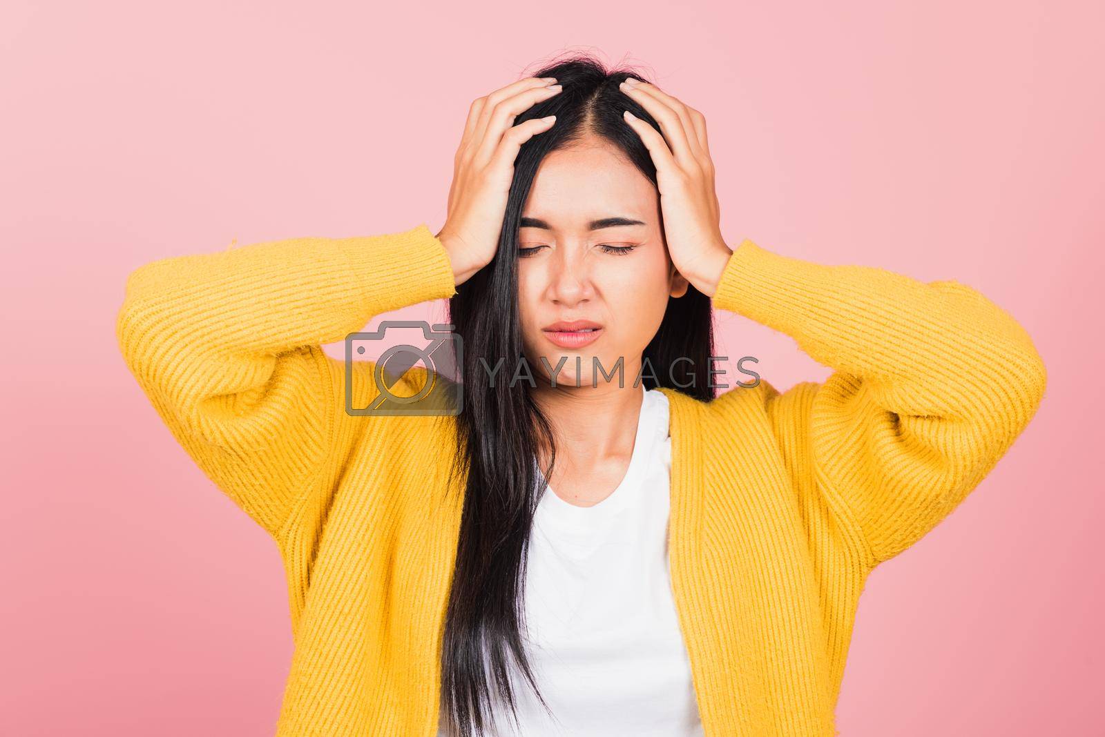 Royalty free image of woman sad tired strain face holding hold head by hands by Sorapop