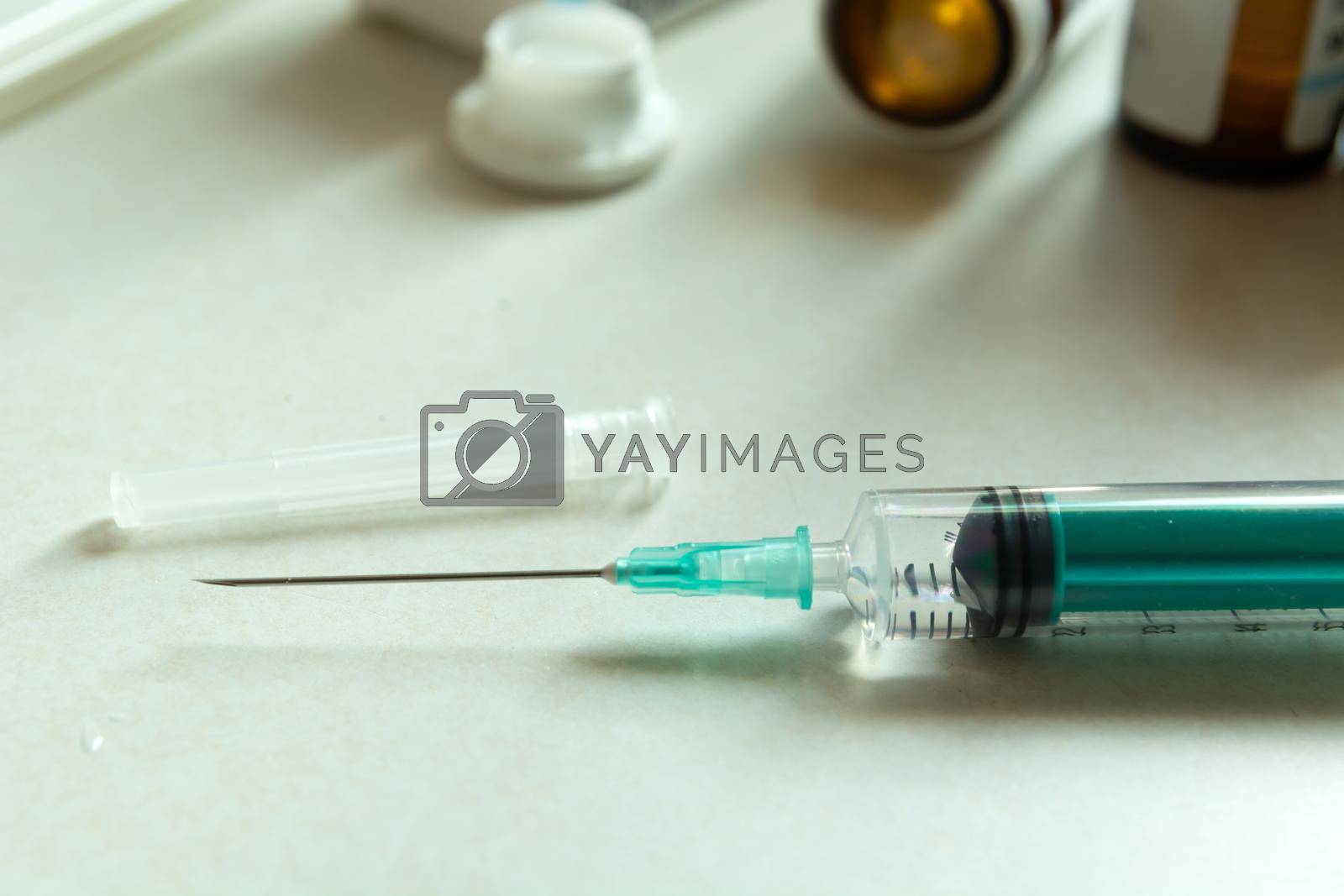 Royalty free image of Closeup of a syringe with a needle on the countertop by darekb22