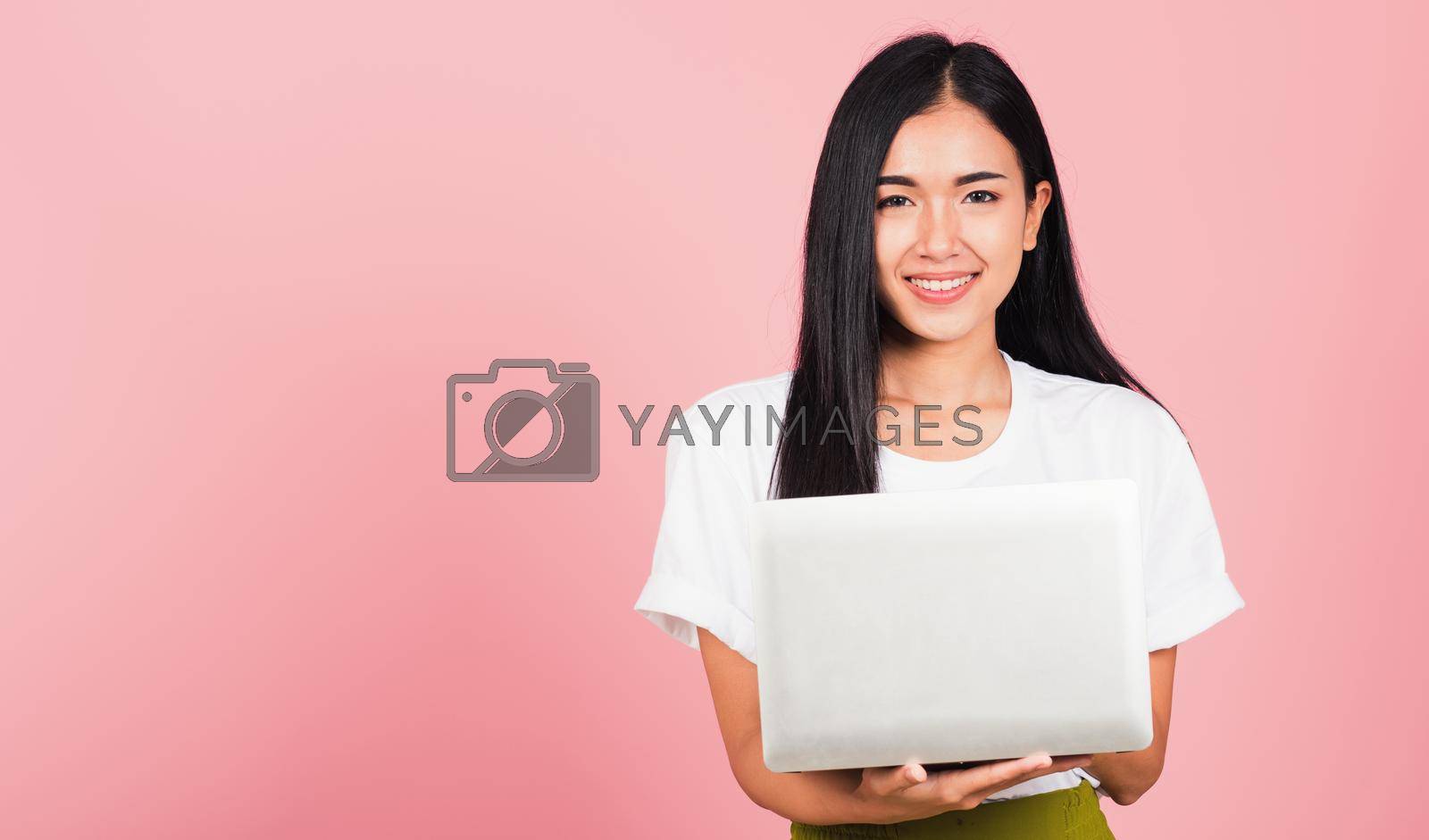 Royalty free image of woman confident smiling face holding using laptop computer by Sorapop