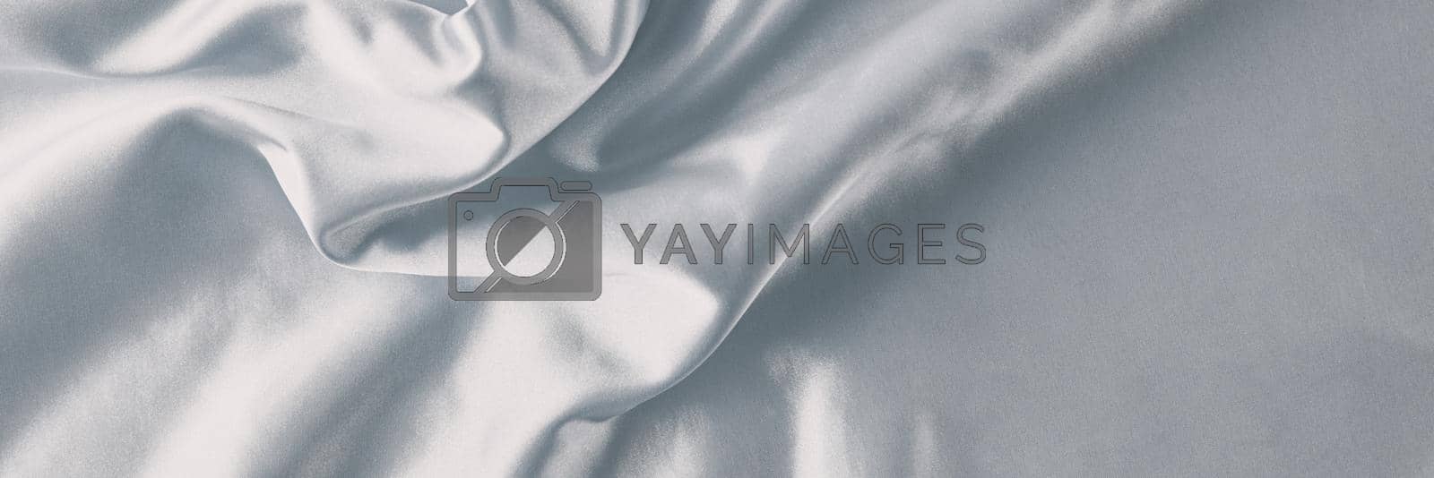 Silver silk background with folds. Abstract texture of rippled satin surface, long banner