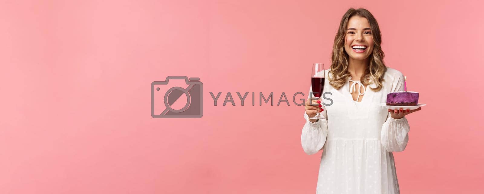Holidays, spring and party concept. Portrait of excited good-looking young tender girl celebrating birthday, having fun with friends, eating b-day cake and drink wine from glass, laughing joyfully.