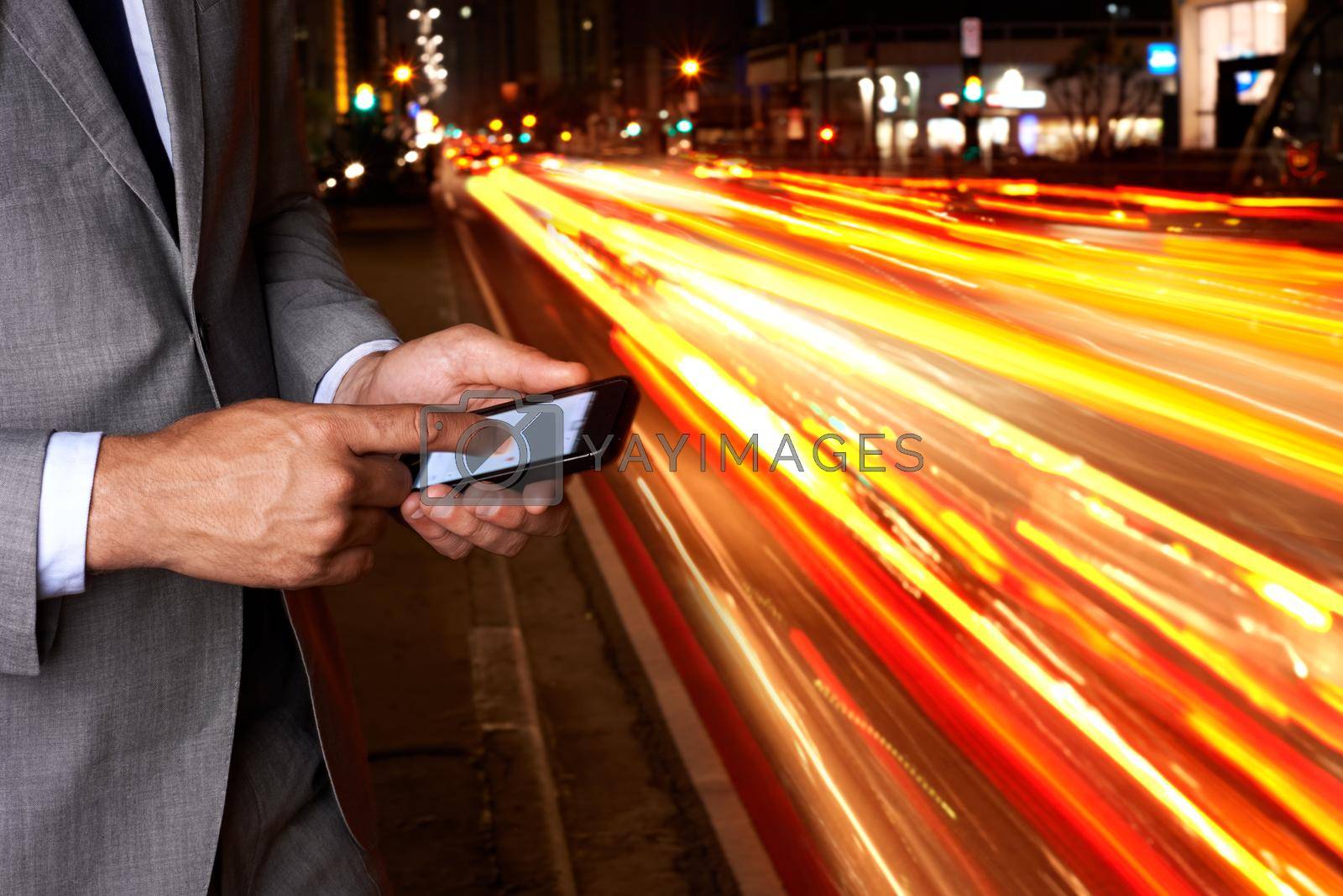 Royalty free image of Modern technology helping him find his way. A cropped shot of a businessman texting while standing beside a busy road. by YuriArcurs