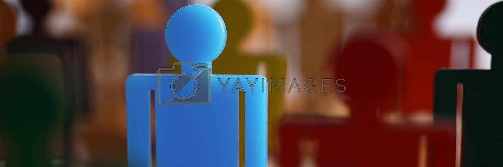 Close-up of one special guy talented businessman person among ordinary people. Unique blue figure in crowded place, stand out idea. Success, leader, career growth concept. Blurred background