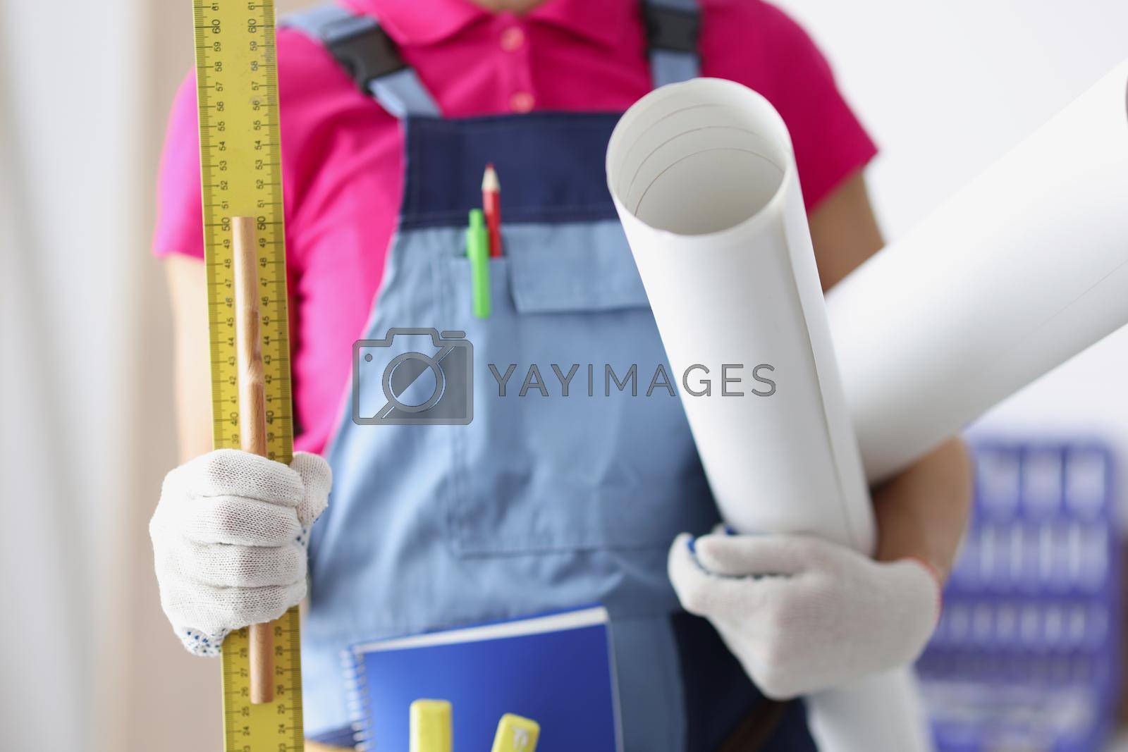 Close-up of person worker holding paper, ruler and pencil. Time to create plan for construction project, make corrections, creative idea, new layout. Foreman, renovation, project concept