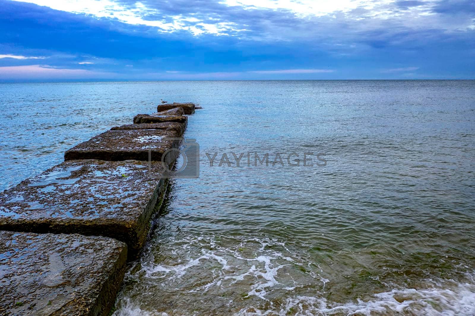 Beauty daily view with clouds of seashore with stone pier and clear water