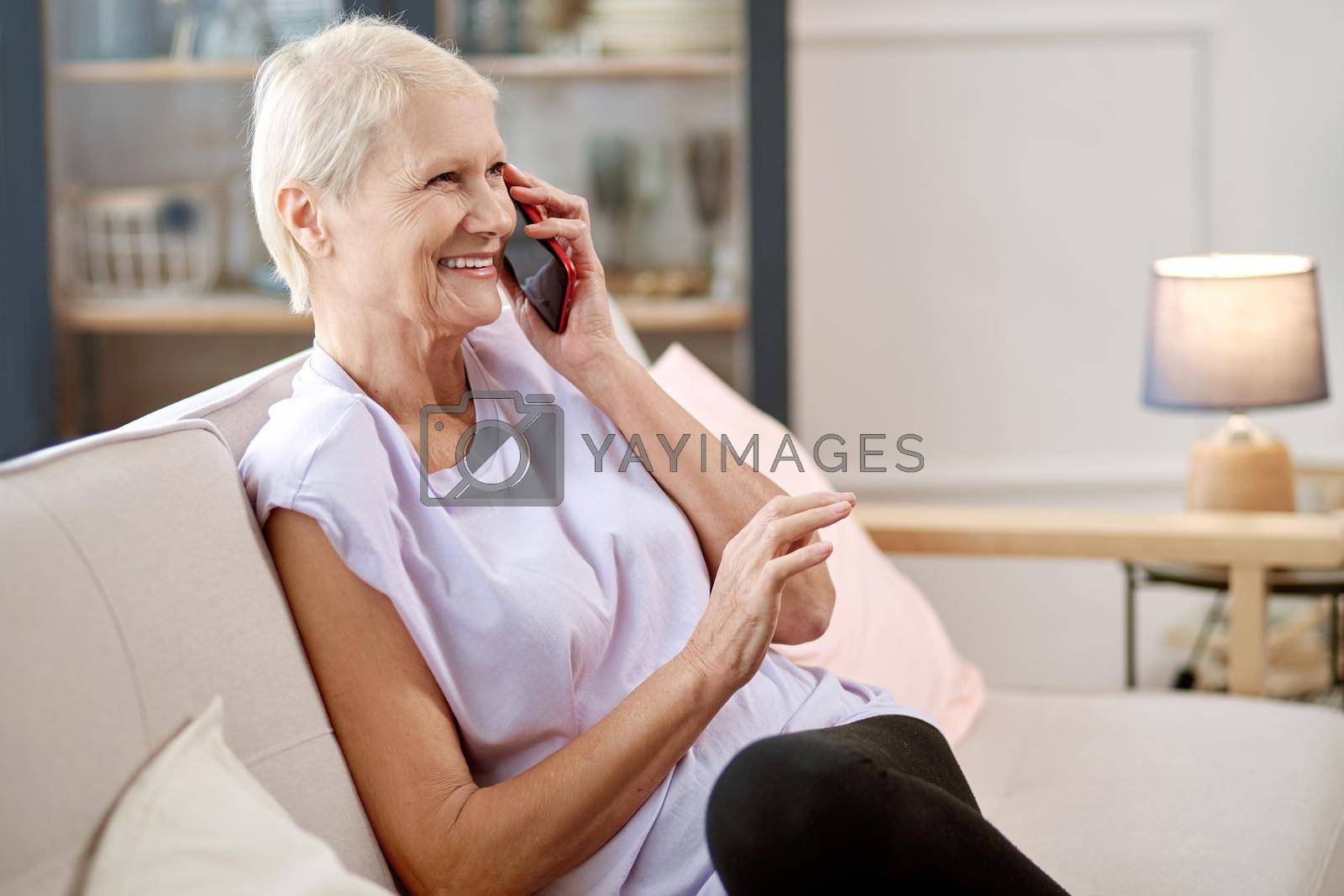 elderly woman sitting in a yoga pose in front of an open laptop. concept of online training.