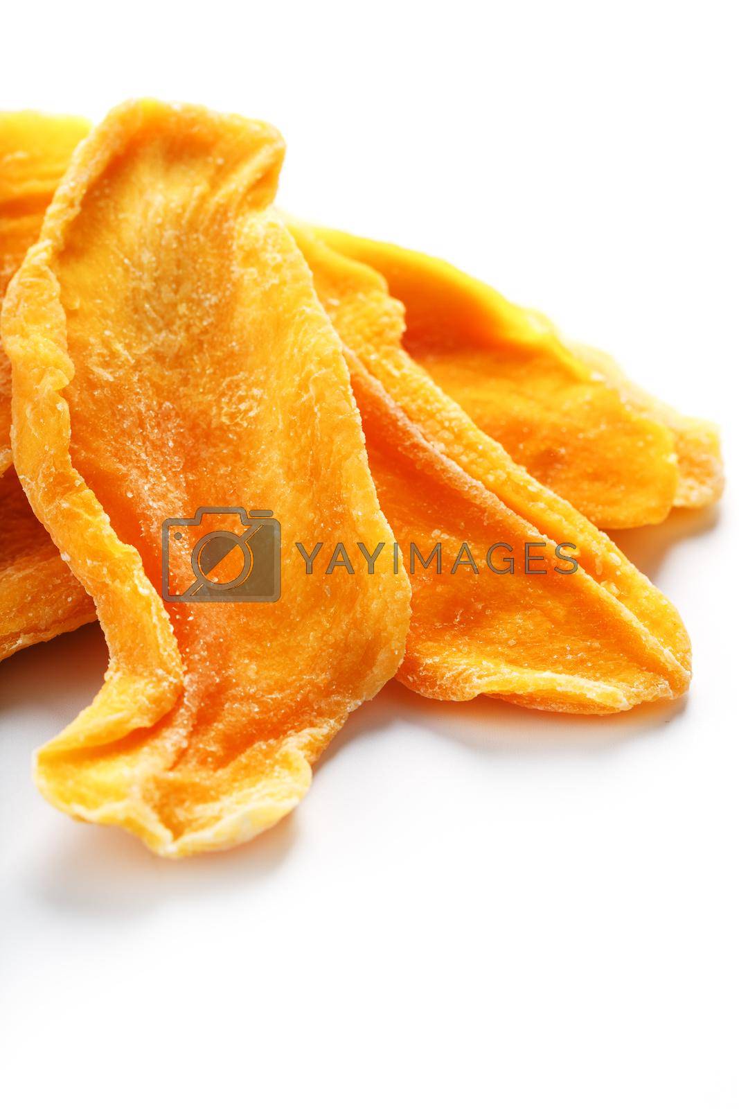 Royalty free image of Dried sweet mango fruit slices as textural orange by AlexGrec
