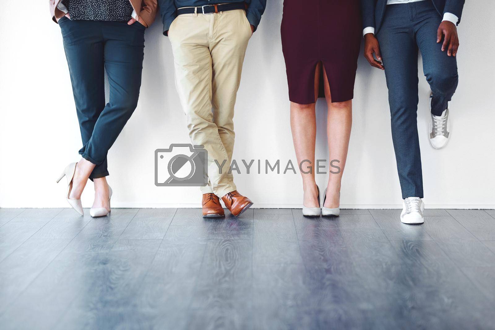 Royalty free image of Its all in your body language. Cropped shot of a group of unrecognizable people standing against a white background. by YuriArcurs
