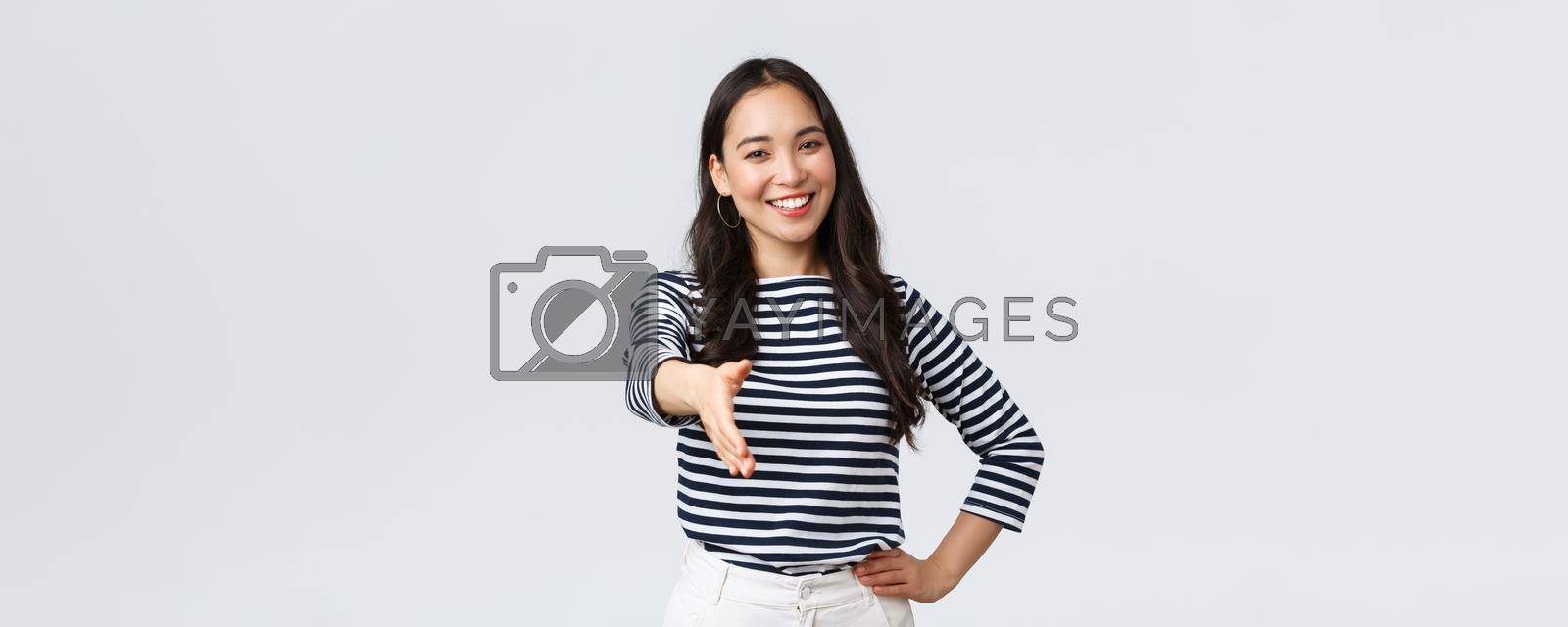 Royalty free image of Lifestyle, people emotions and casual concept. Friendly outgoing asian woman extend hand for handshake, have business meeting, say nice to meet you, greet new people in company by Benzoix