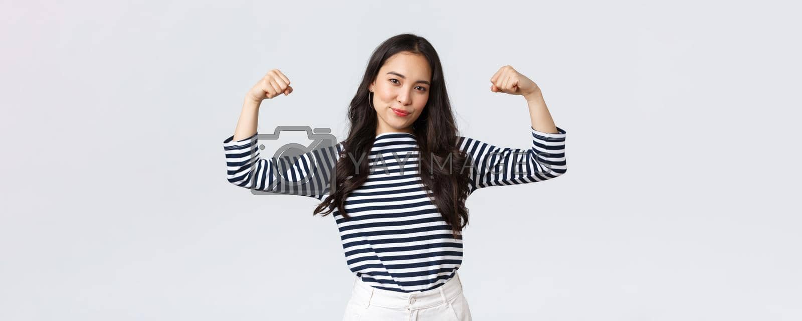 Royalty free image of Lifestyle, people emotions and casual concept. Strong and confident asian woman flex biceps, bragging her perfect shape after sign-up gym membership, brag with muscles, workout and feeling strong by Benzoix