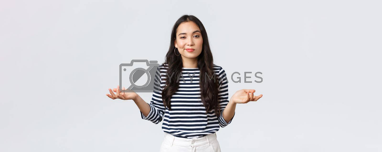 Lifestyle, beauty and fashion, people emotions concept. Clueless and unbothered asian woman shrugging with hands spread sideways and unaware smirk, standing white background.