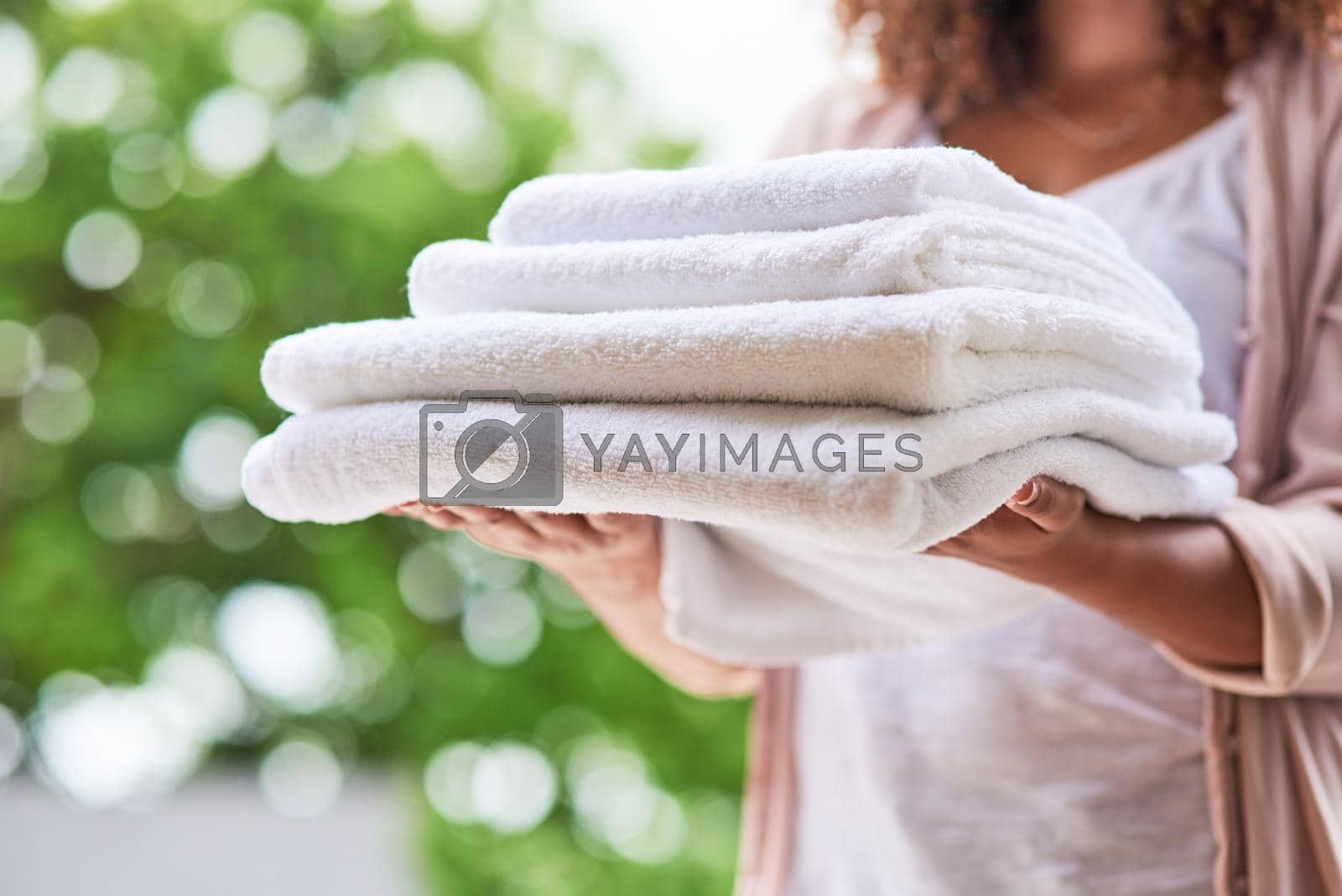 Royalty free image of Another successful laundry day. Shot of an unrecognizable woman doing laundry at home. by YuriArcurs
