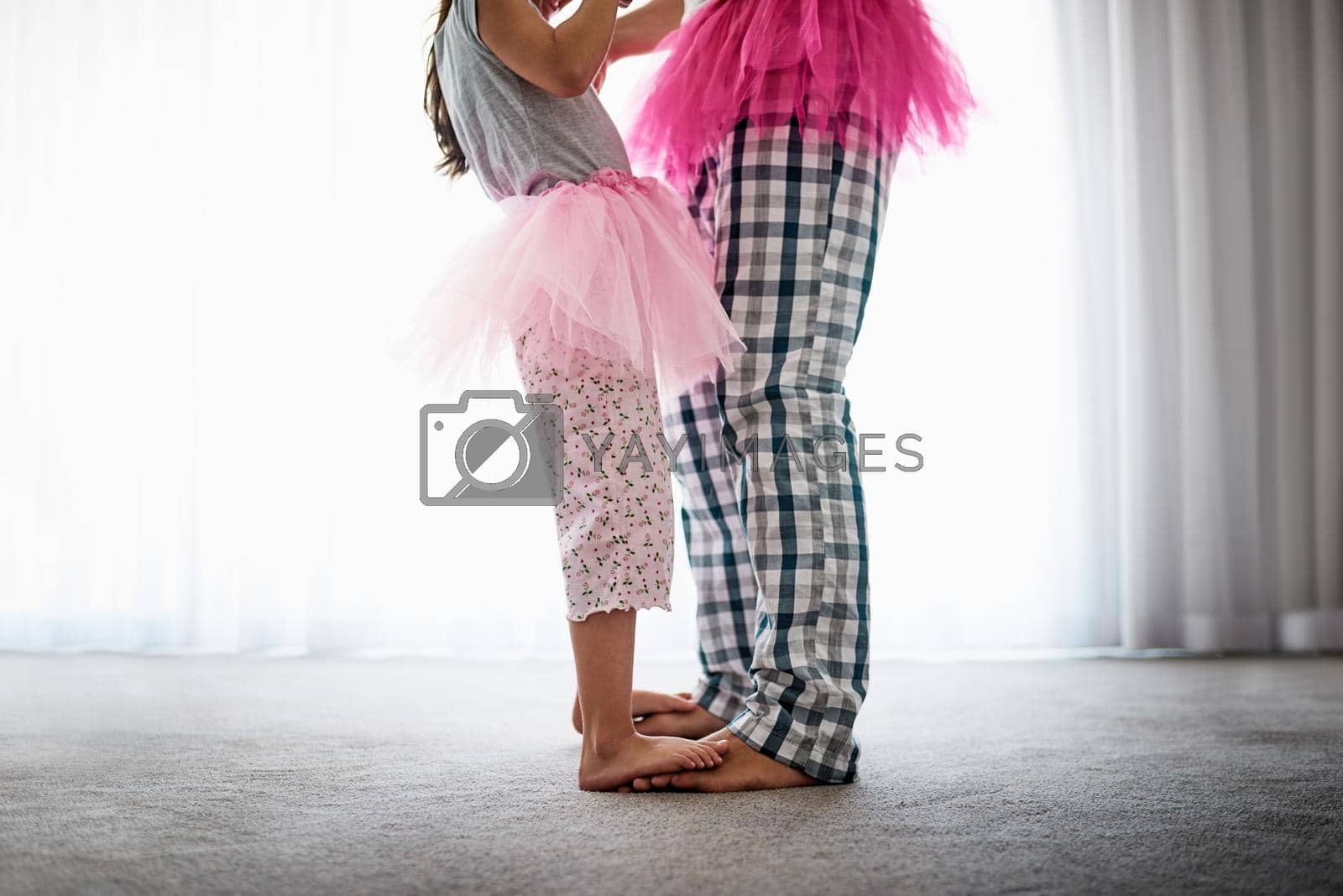 Cropped shot of an unrecognizable father and his daughter dancing at home.