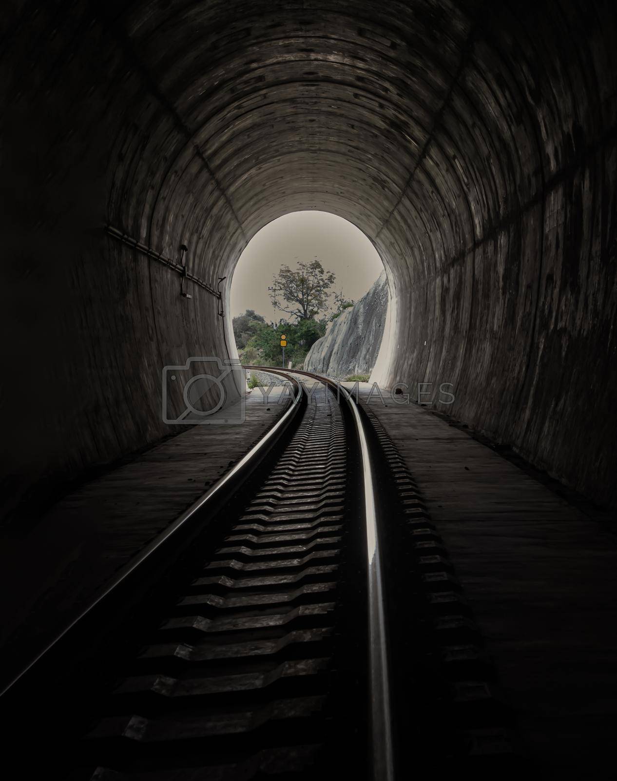 Inside the railroad tunnel and railways with natural light at the end. Light at the end of the tunnel, Lights and shadows, Concept of achieving your goals, Copy space, Selective focus.