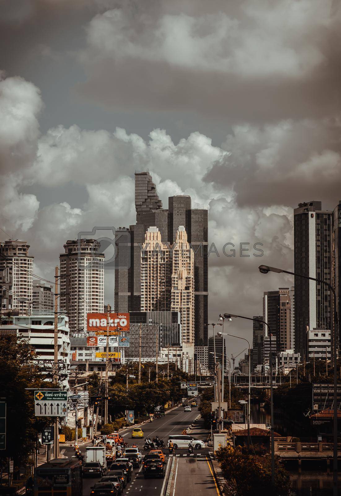 Bangkok, Thailand - Mar 27, 2022 : Cityscape and Street traffic with modern office buildings at Sathorn road. No focus, specifically.