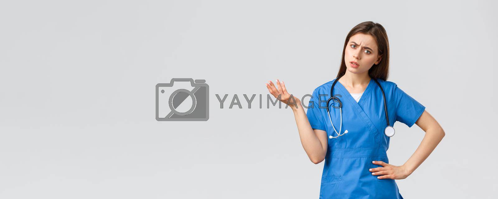 Healthcare workers, prevent virus, insurance and medicine concept. Confused and puzzled female nurse, doctor in scrubs with stethoscope, shrugging and lift hand, stare indecisive, cant understand.