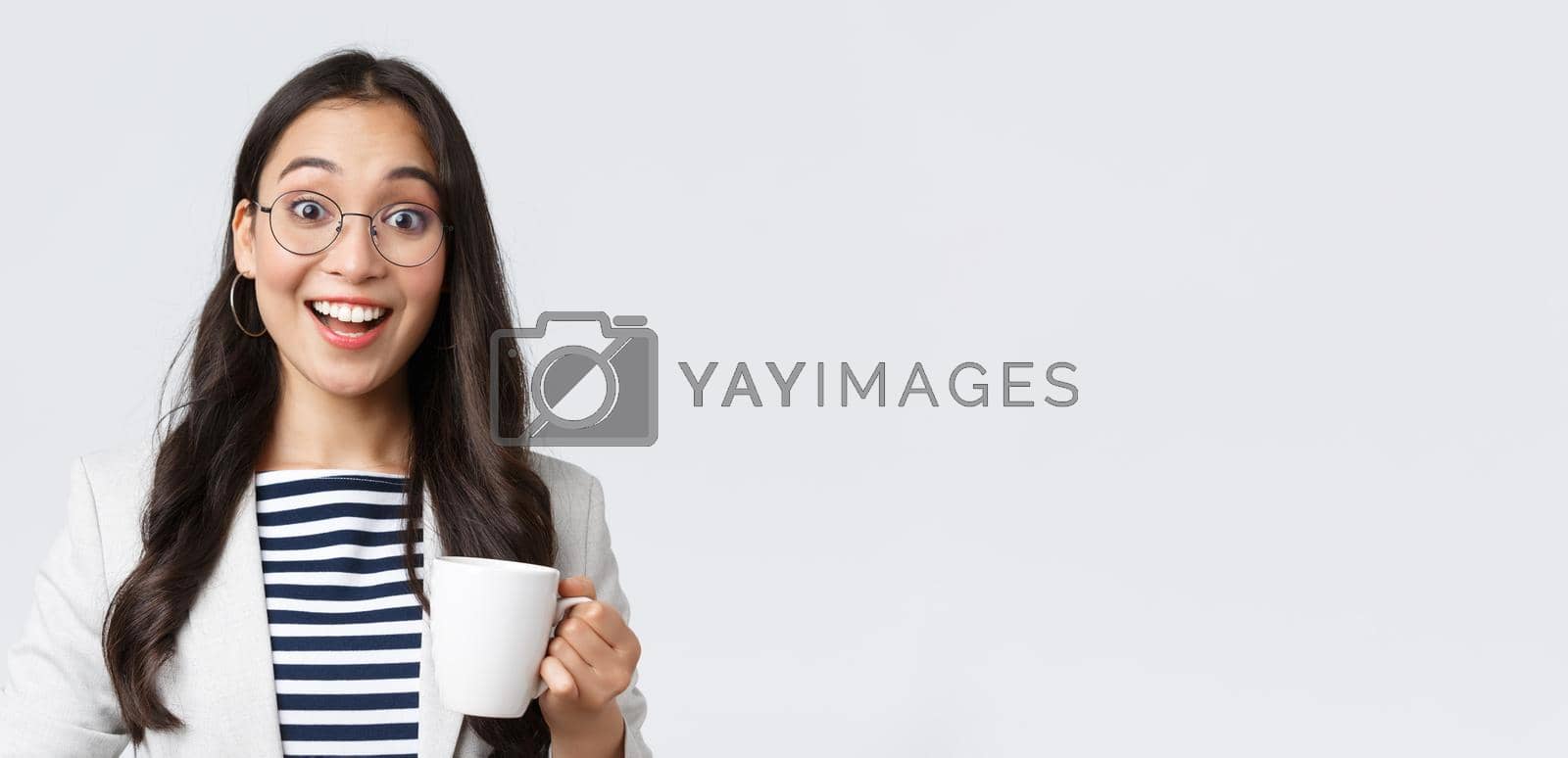 Royalty free image of Business, finance and employment, female successful entrepreneurs concept. Close-up of outgoing smiling asian office worker talking to coworker at office kitchen, drinking coffee by Benzoix