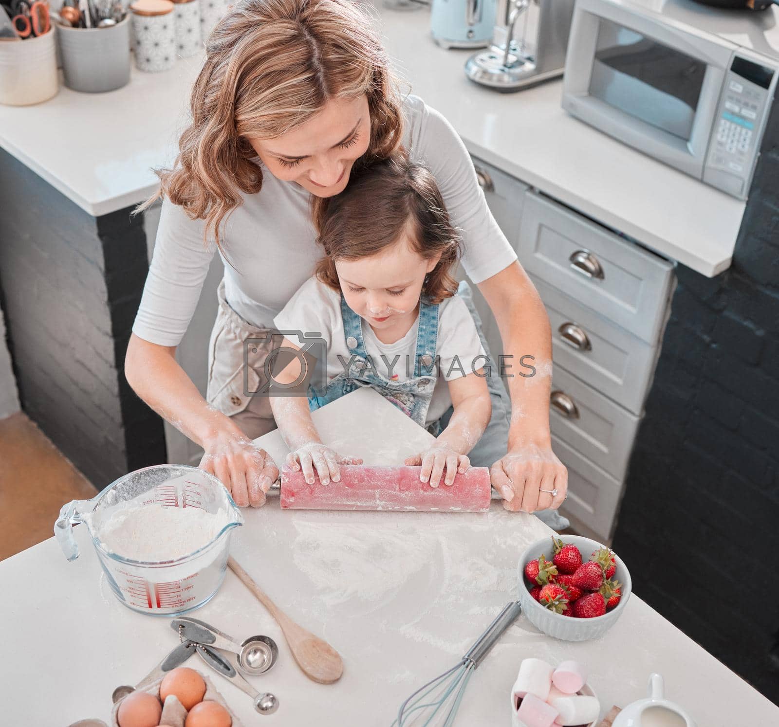 Shot of a mother and daughter baking in the kitchen at home.