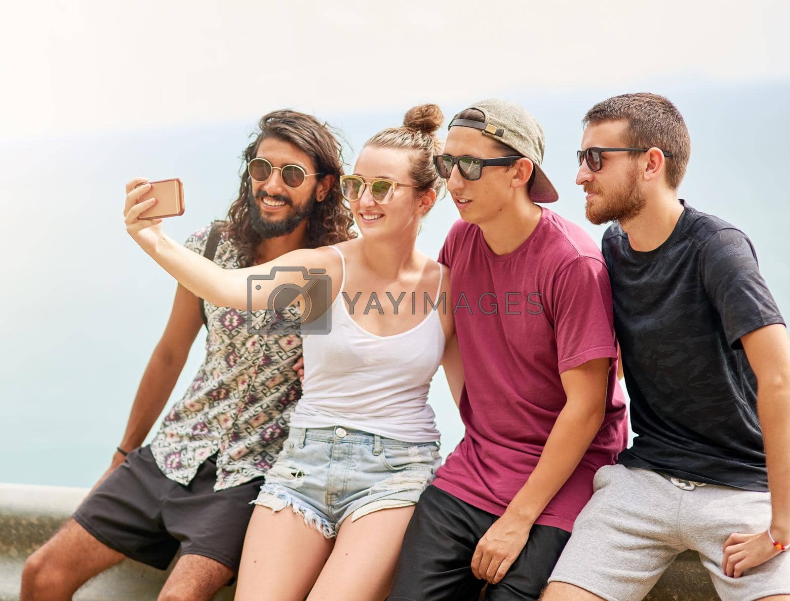 Shot of a group of friends posing for a selfie while relaxing together outside.