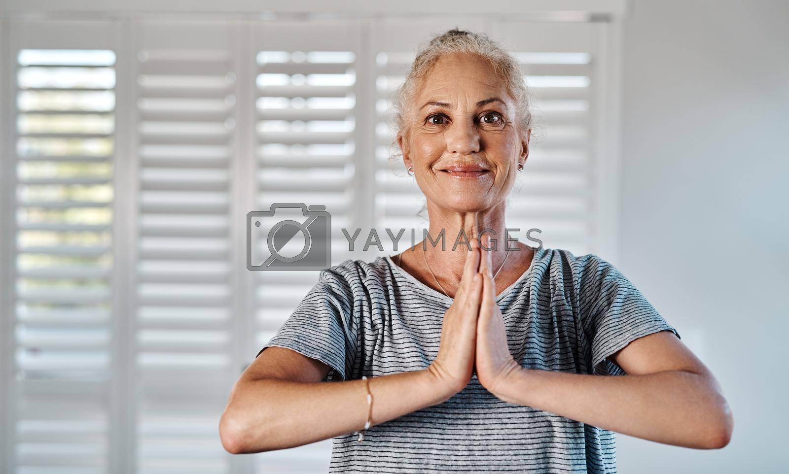 Portrait of a cheerful mature woman practicing yoga inside of a studio during the day.