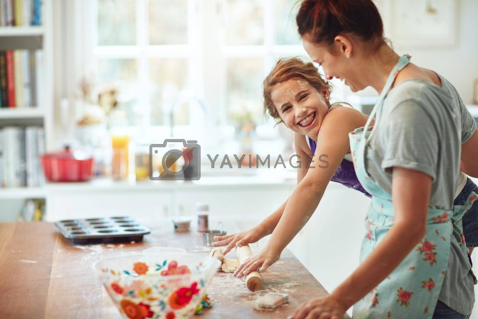 Shot of a mother and daughter preparing food in the kitchen at home.