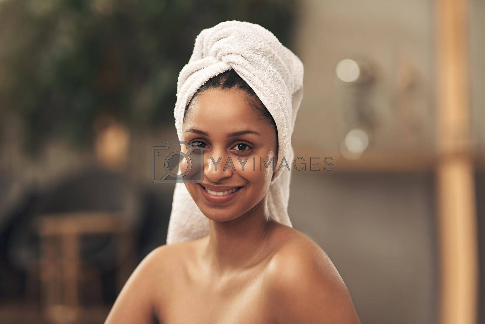 Shot of a woman wearing a towel around her head while enjoying a spa day.