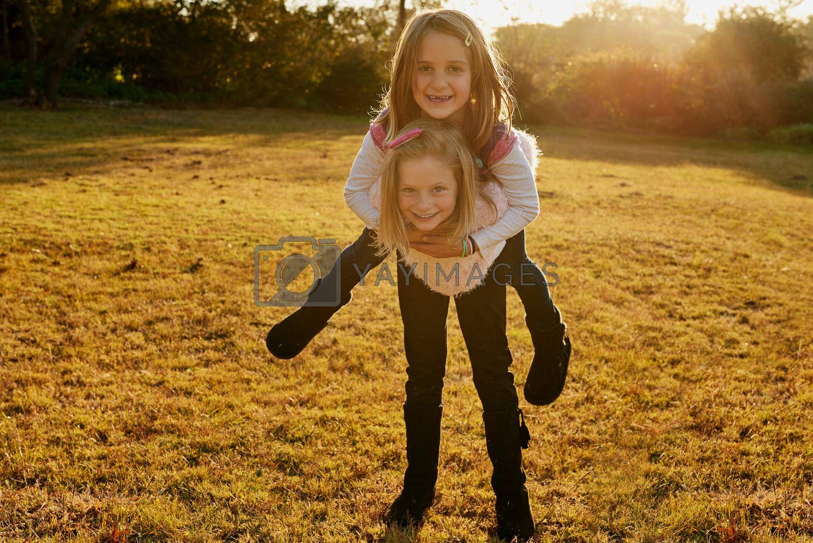 Portrait of two little girls having fun outside.