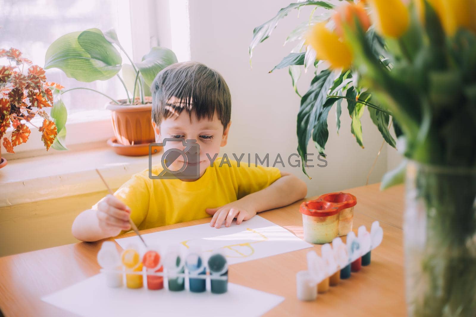 The boy paints a lifestyle . Children's hobby. Leisure at home. Children's drawings. Psychology of children's drawings. Child development.