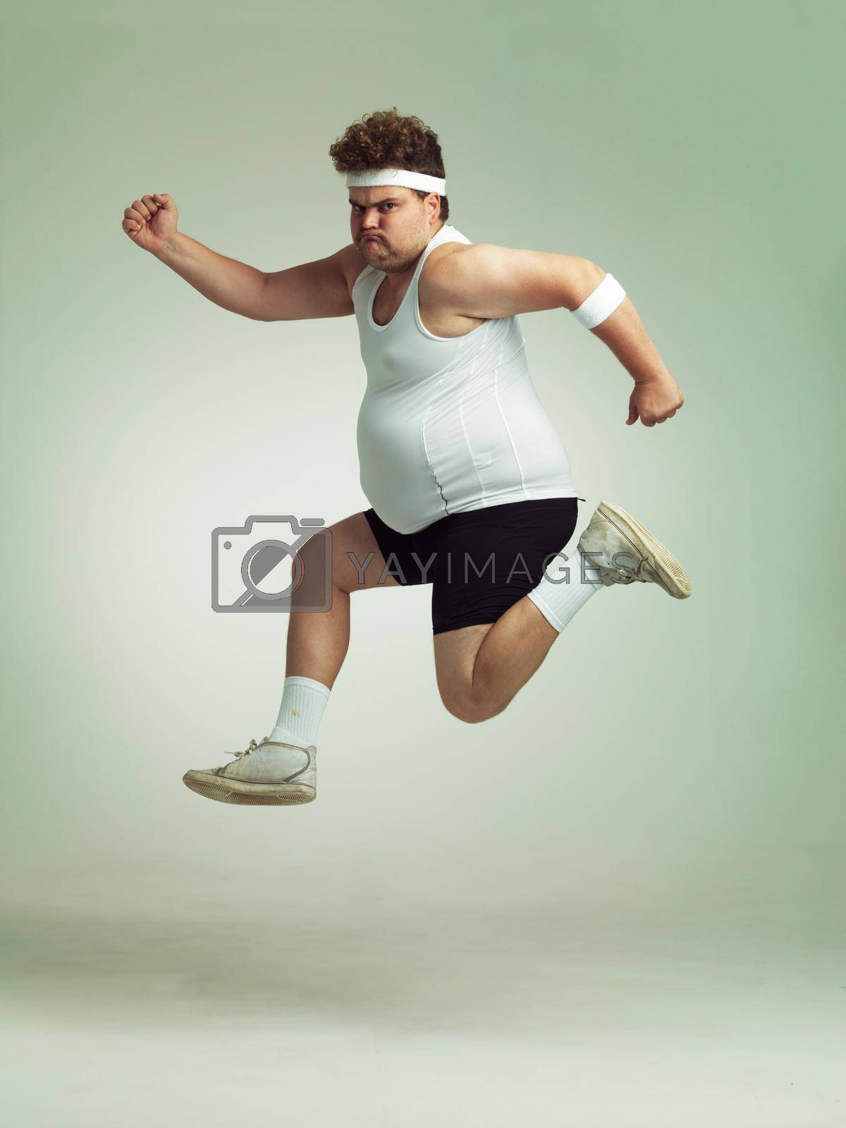 Royalty free image of I feel in shape already. Overweight man leaping in the air with his sense of achievement. by YuriArcurs