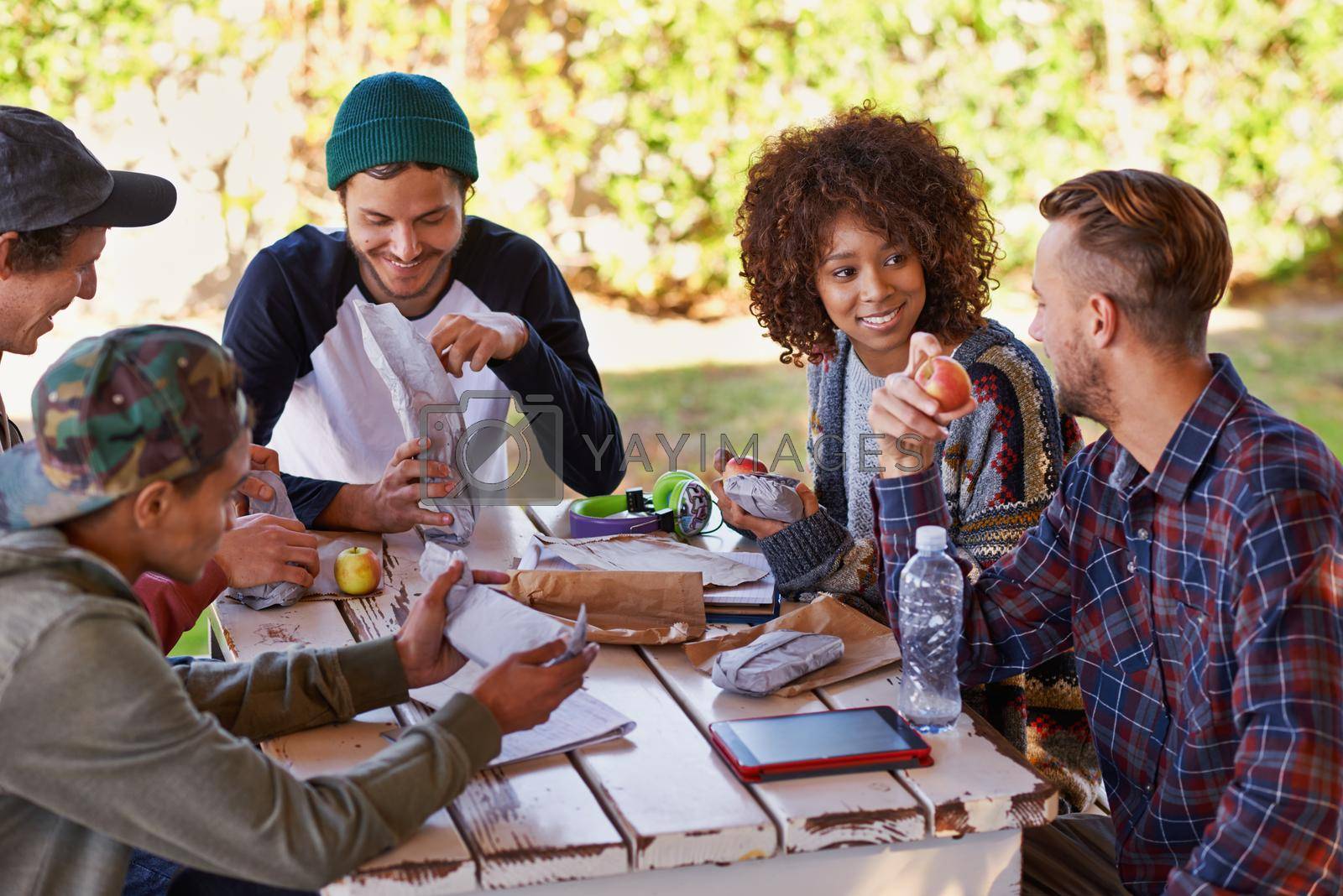 A group of friends around an outdoor table.
