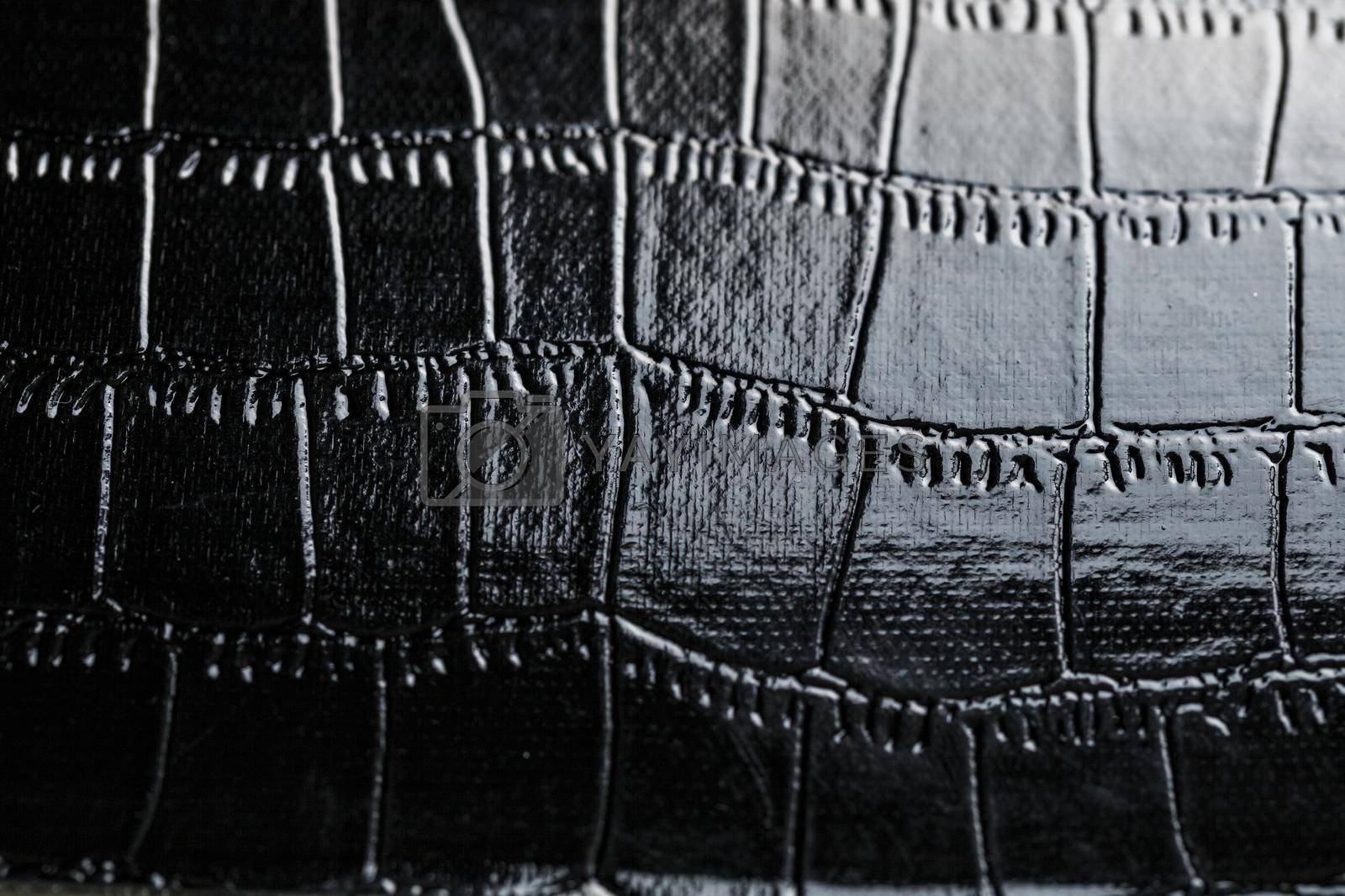 Black crocodile skin texture as background in full screen closeup