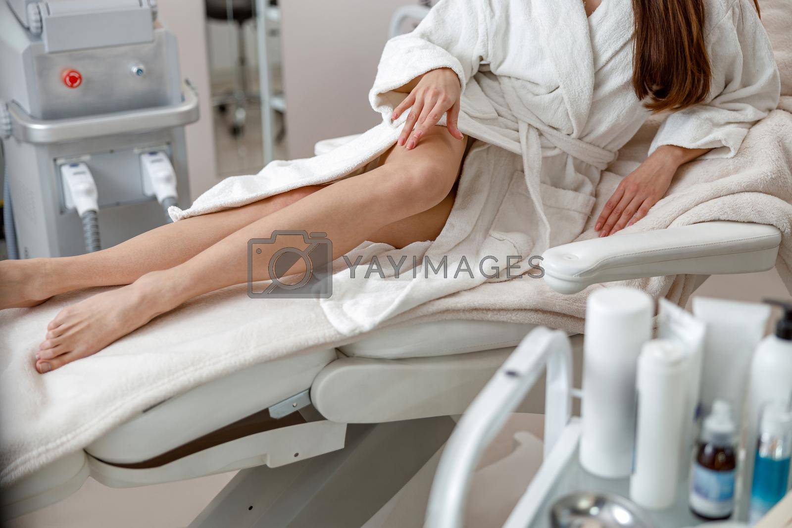 Perfect smooth legs of woman in spa center after beauty procedures. Laser epilation concept