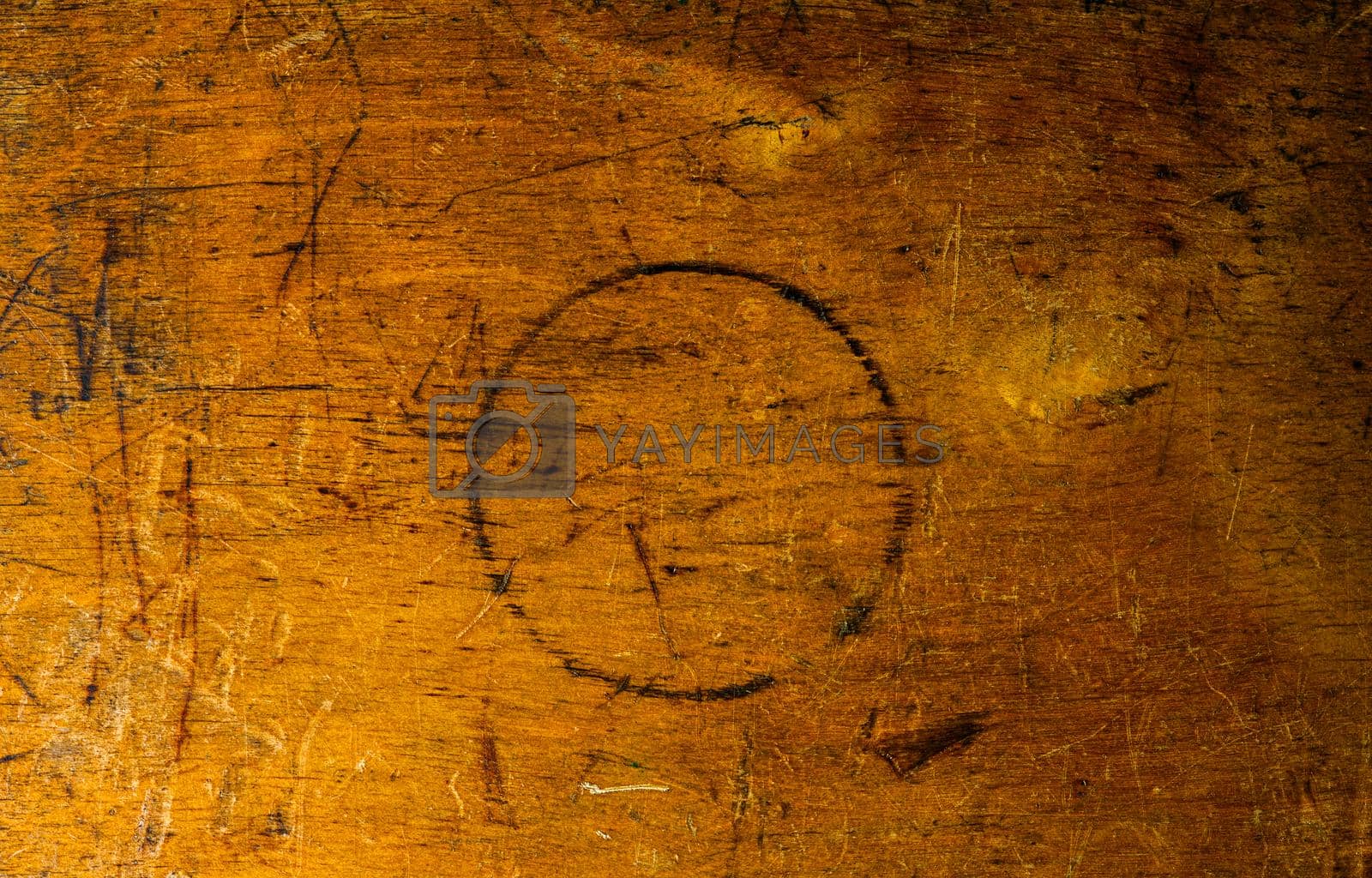 Side of old used wooden toolbox with round burn in center