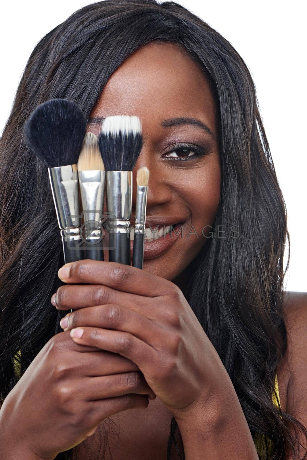 Studio shot of a young woman holding a makeup brush isolated on white.